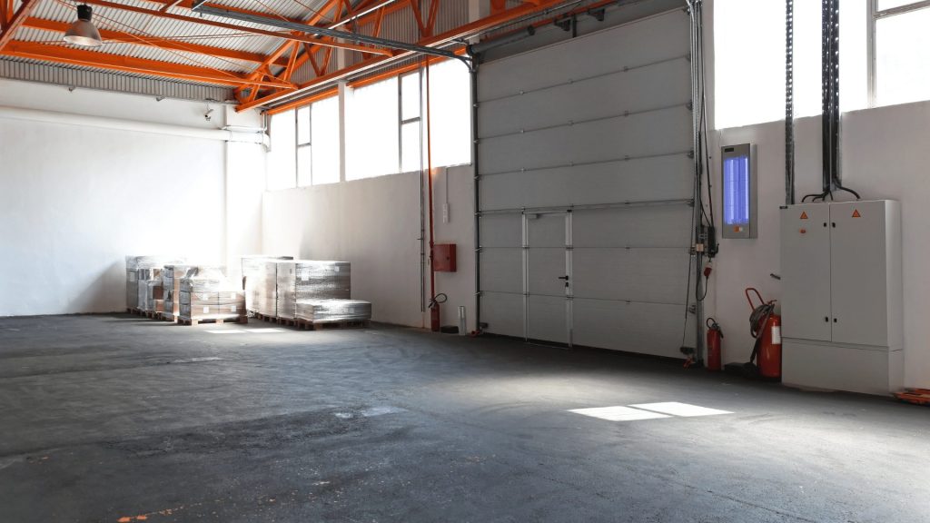 Garage door maintenance technician at work on a commercial property in Sutherland Shire