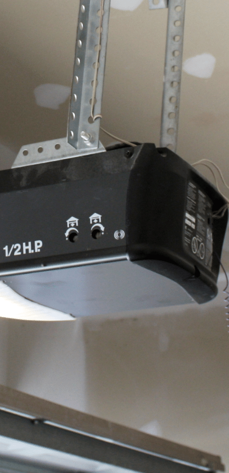 Garage door opener motor mounted on a garage ceiling