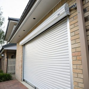 White steel roller garage door with horizontal slats partially open on a modern Australian home