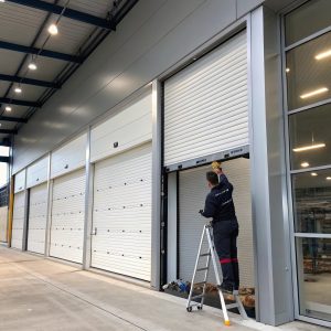 Commercial roller door being installed by a technician