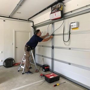 A garage door being attended to by a technician in Sutherland Shire